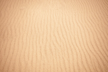 Clean yellow sand on a beach as background