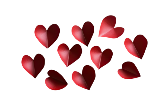 Red paper hearts scattered on black background