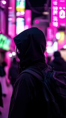 Individual wearing a black hooded jacket stands in a vibrant urban environment illuminated by colorful neon lights, creating a mysterious and atmospheric scene