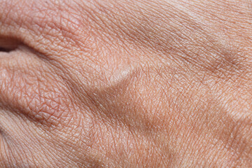 Close-up macro of human hand skin texture,The skin texture of Asian men's feet is tan or brown. Men's feet skin background 