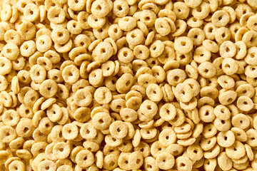 Whole grain cereal rings  texture, close up, top view. Crispy healthy cereal rings as background.