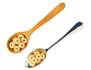 Whole grain cereal rings in a metal spoon isolated on white background, top view.