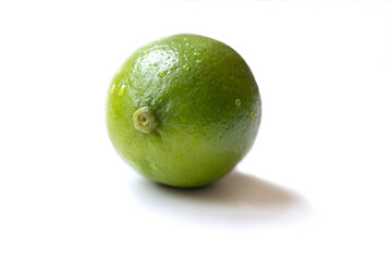 Fresh, vibrant green limes on a clean white surface. Juicy citrus fruits symbolizing summer freshness and healthy living. Selective focus creates a bright, inviting mood.