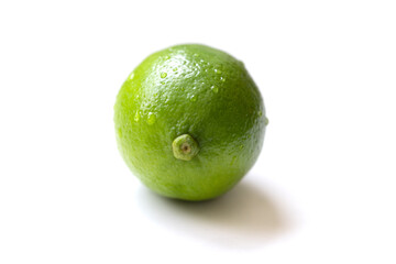 Fresh, vibrant green limes on a clean white surface. Juicy citrus fruits symbolizing summer freshness and healthy living. Selective focus creates a bright, inviting mood.