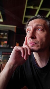 A contemplative and hopeful mood is captured as a person looks upwards with a hand on their chin, suggesting deep thought, inspiration, or pondering future possibilities