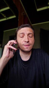A pensive and concerned mood is captured as a person on a phone call looks upwards, as if seeking answers or contemplating a serious issue. It's ideal for depicting problem-solving, deep thought