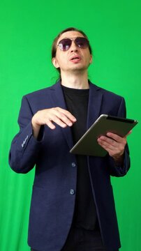 A mid-shot captures an energetic and motivational mood as a man in a suit jacket and sunglasses gestures expressively while speaking, ideal for impactful business or inspirational content