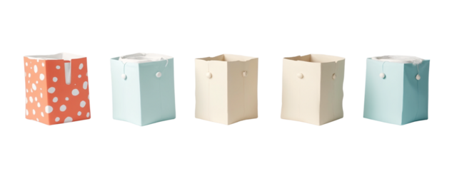 A set of four different colored paper bags with white polka dots on them.