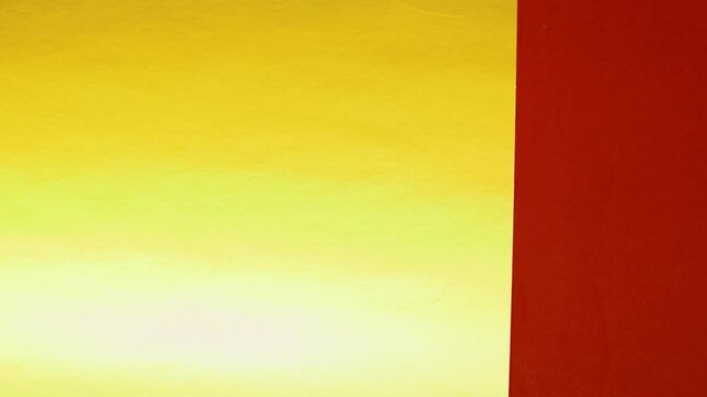 Vivid construction paper backgrounds in bold colors are gently animated by soft, natural shadows gliding across the surface, creating depth, movement, and visual warmth.