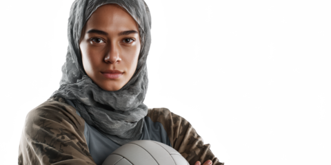 Muslim Woman Volleyball Player: A strong and determined Muslim woman in a hijab confidently holds a volleyball, embodying resilience and sportsmanship.