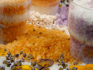Aromatic relaxing herbal and floral sea bath salt in the jars, various dried plants for making...