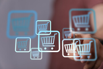 Person interacts with digital shopping cart icons, representing online shopping and e-commerce.