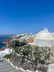 church in oia santorini greece framed with flowers