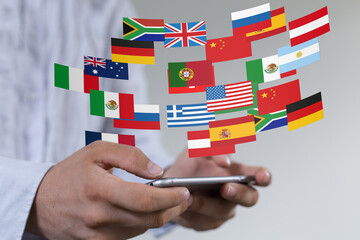 Image of a person using a smartphone with various national flags appearing, symbolizing global...