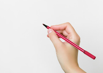 Hand holding a red pen on a white background