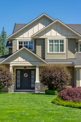 Entrance of grey painted luxury house in spring with stair steps and nice landscape in Vancouver,...