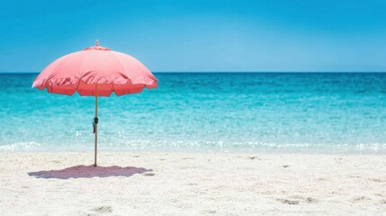 Bright pink umbrella on a serene sandy beach with clear blue water