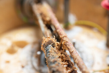 Corrosion and mineral deposits on the heating element of an electric boiler. Boiler maintenance and repair