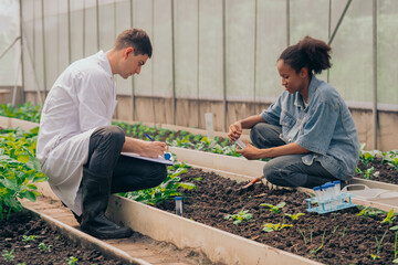 Teachers and students test and research soil for agriculture, farming, and cultivation in...