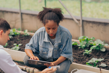 Teachers and students test and research soil for agriculture, farming, and cultivation in...