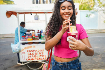 Young woman enjoying a raspado from a street vendor in Guayaquil, Ecuador © Ivan Muñoz Colorado