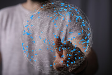 Abstract image of a hand interacting with a digital global network, representing connectivity and...
