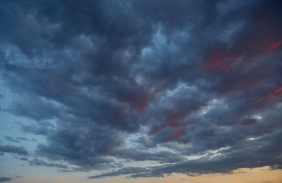 Dark clouds with bloody red edges, as if foretelling the apocalypse. Extreme weather events, natural disasters. The end of an era and the need for adaptation.