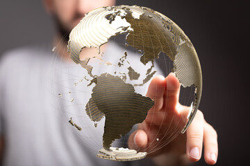 Person touching a digital globe, representing global network, internet, communication, and...