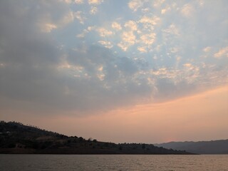 Mountain silhouette beneath pastel dusk sky