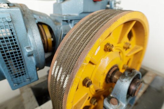 Detailed view of an industrial elevator's pulley system, showcasing the cables and machinery.