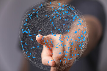 Abstract image of a hand interacting with a digital network, representing global connectivity and...