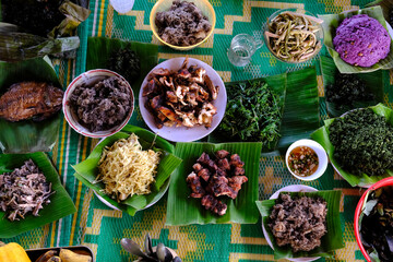 Traditional festive meal in a village on the highlands. Rice cooked over a wood fire in a bamboo pot. Kontum. Vietnam.