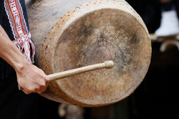 Traditional ceremony in a Bahnar ethnic village in the Kontum region. Young people in traditional clothing playing percussion instruments. Kontum. Vietnam.