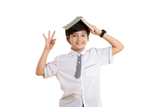 Portrait of Asian kid boy wearing school uniform and holding book posing on  png background	
