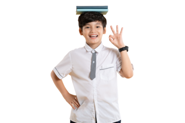 Portrait of Asian kid boy wearing school uniform and holding book posing on png background
