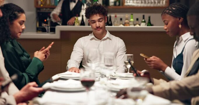 Lonely, man and friends with smartphone, restaurant or group with tech for texting or communication. Depressed, customer and people with mobile, typing and sad on break in diner, online and thinking