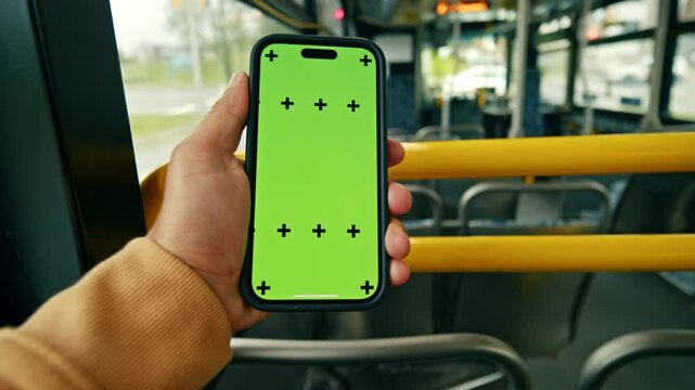 Close-Up POV Of A Man Holding Smartphone With Chroma Key Screen While Sitting By A Window On A Moving Train Or Bus. Camera Focuses On The Green Display.