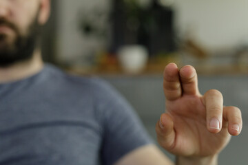 Close-up of a man's hand reaching out, slightly blurred background. Ideal for technology,...