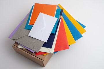 Paper envelopes on a light background. New mail, write a message. Send and receive mail. Postal delivery service. Empty envelope, empty space. Communication with people, paperwork. Envelope close-up