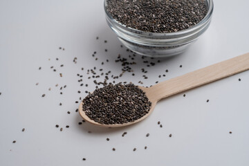 Chia seeds in a wooden spoon on the table. Superfood. Antioxidants for health
