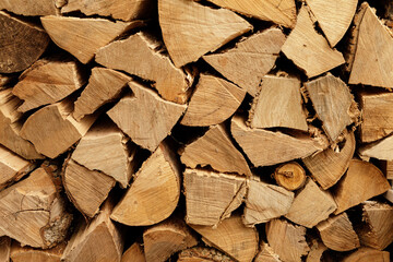 High-resolution image of neatly stacked firewood logs, perfect for autumn or winter themes.