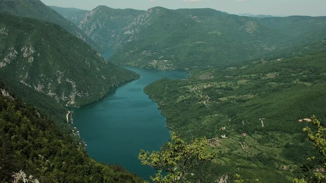 View of the winding Drina River between lush green mountains in Tara National Park, Serbia. Perucac - Peruchac lake. Banjska Stena viewpoint. 4k horizontal footage