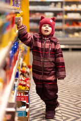 The child looks with a request to buy