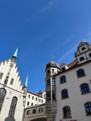 Stunning Architectural Detail of Munich Historic Downhill Building Against a Clear Blue Sky