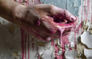 red paint dripping from hand