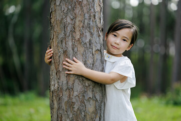 Child Hugging Tree Promoting Forest Conservation
