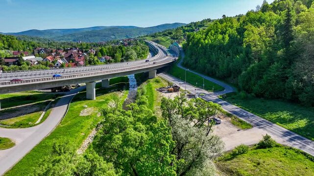 New elevated multilane highway and bend over old Zakopianka road in Lubien village in Poland, This motorway makes travel to Zakopane, Podhale region and Slovakia much faster. Aerial 4K video