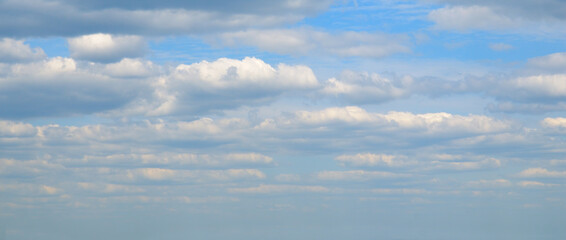 clear blue sky with a few clouds. The sky is very bright and the clouds are scattered throughout.