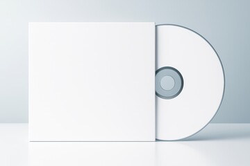 Blank white CD case and disc on glossy surface with soft light background for clean product mockup, design presentation, or advertising concept.