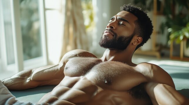 A muscular man lies relaxed in sunlight, embodying tranquility and self-care, representing the balance of fitness and mental wellness in a serene environment.